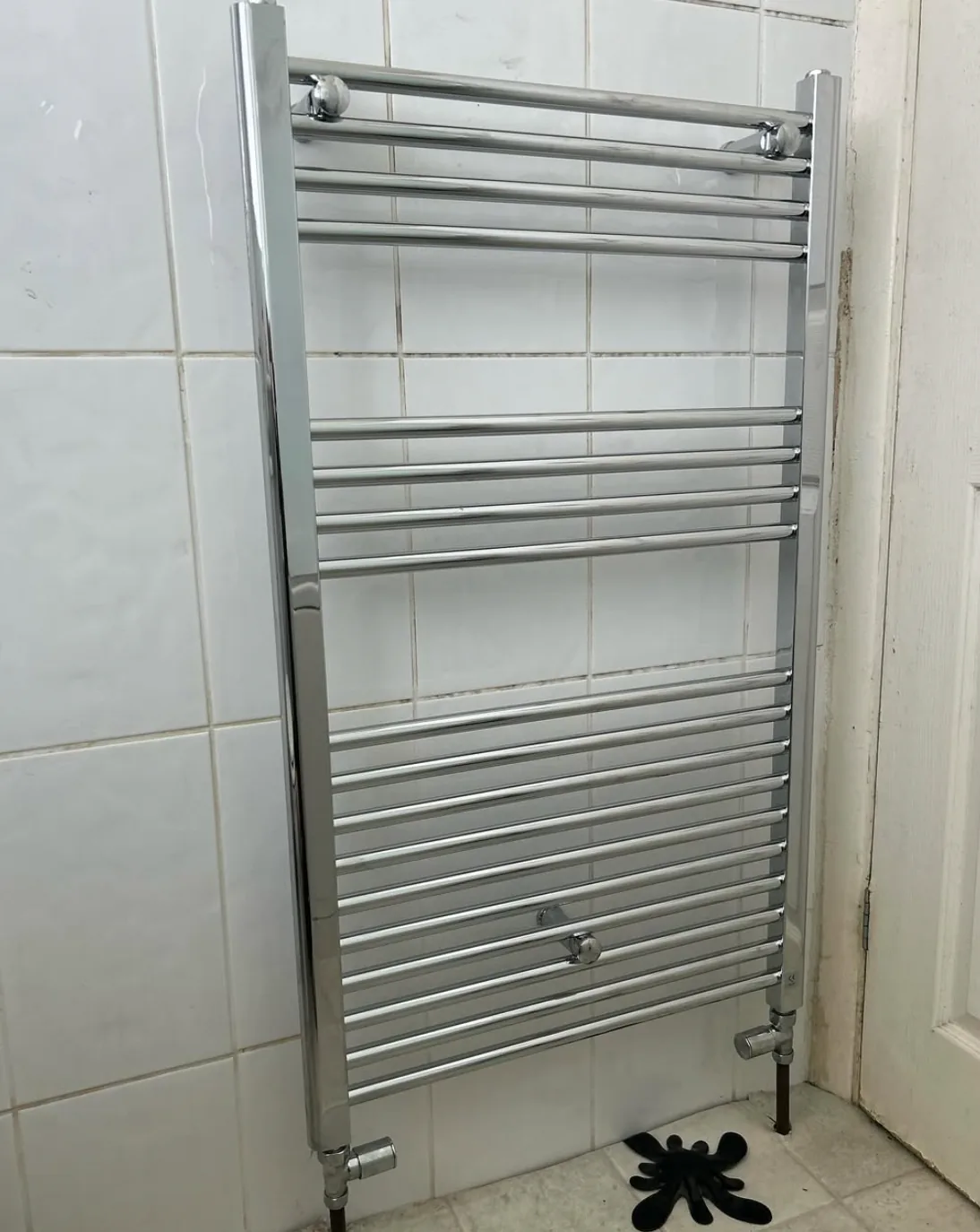 Chrome towel radiator installed in a bathroom by Infinite Plumbing & Heating